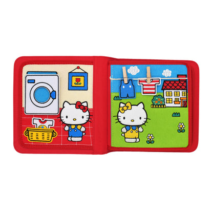 Hello Kitty vor einer Waschmaschine und an einer Wäscheleine  mit Kleinteilen als Übung für Kleinkinder